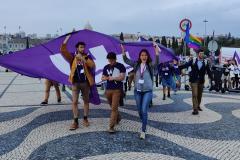 Volters hold a Volt flag during public action in Lisbon