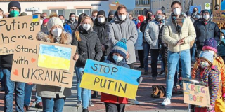 Solidaritätsbekundung mit der Ukraine in Erding, Plakate mit "Stop Putin", "Putin go home" und "Stand with Ukraine" im Vordergrund