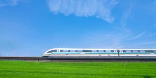 High speed train travels through countryside on a clear sky day